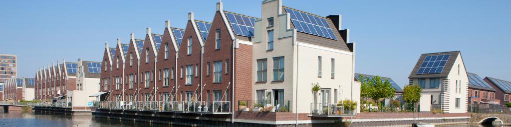 Huizenblok met zonnepanelen aan het water